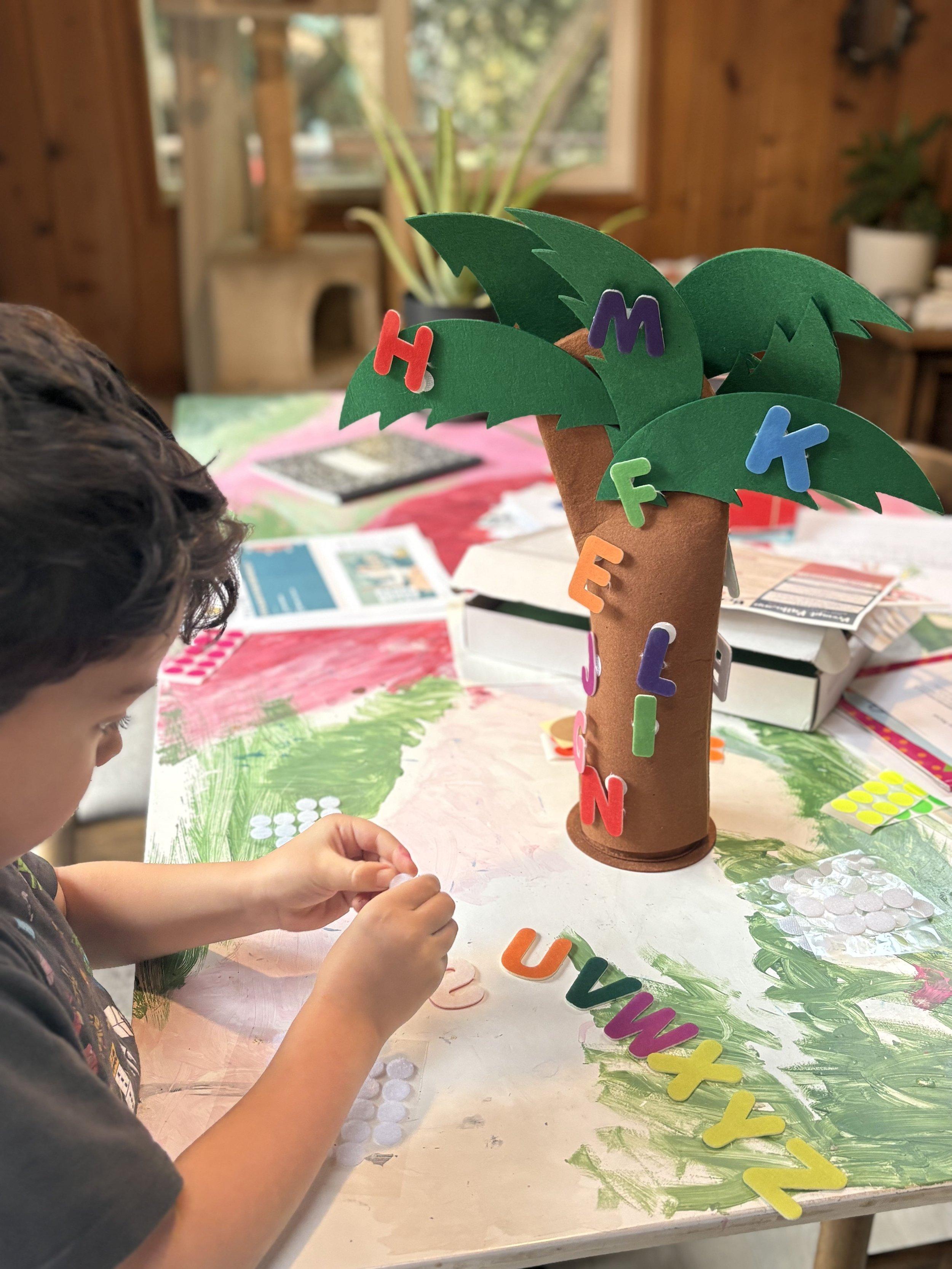 A young child assembling a colorful letter activity